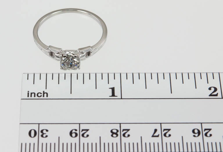 This very sweet Art Deco engagement ring features an Old European Cut 0.55ct G-SI2 (EGL) diamond and two small emerald cut diamonds on the shoulder with open work and millegrain detailing, circa 1930s. 

Currently a US size 6.5 and easily