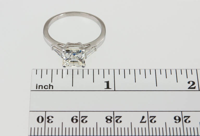 Understated elegance! This platinum diamond engagement ring features a beautiful 2.02ct H-SI1 (EGL) square emerald cut diamond and two tapered diamond side baguettes- a very clean, timeless design! Circa 1940s.
Currently a US size 6.25 and easily