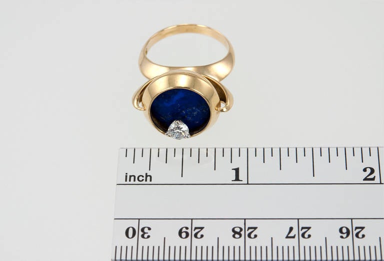 An interesting and very cool lapis lazuli diamond spinner ring in 18K yellow gold. The diamond is approximately 0.33 carats and spins in a circle around the lapis with movement. Circa 1980s.
Currently a US size 6.25 and easily adjustable.