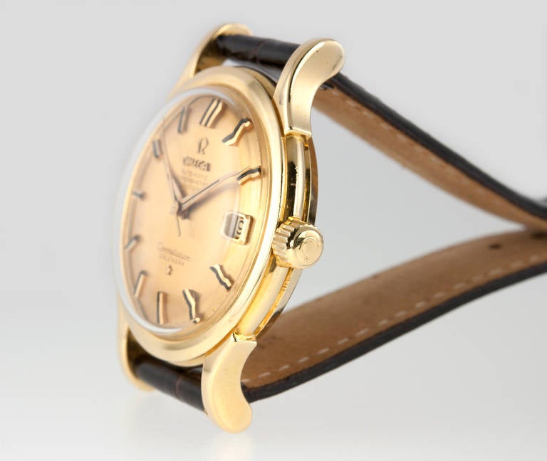 Omega 18k yellow gold Constellation wristwatch. This collectible and rare Omega watch features a 561 caliber automatic chronometer date movement, original pie-pan gilt dial, flared large lugs, waterproof case, on a new leather strap. Circa 1960.