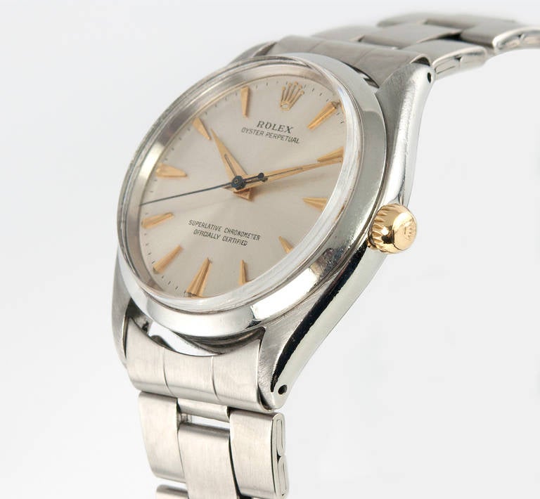 Rolex stainless steel Oyster Perpetual wristwatch, Ref. 1003. This watch has an original silvered satin dial with yellow gold markers, and a yellow gold waterproof crown, smooth stainless steel bezel, a plastic crystal, Oyster stainless steel