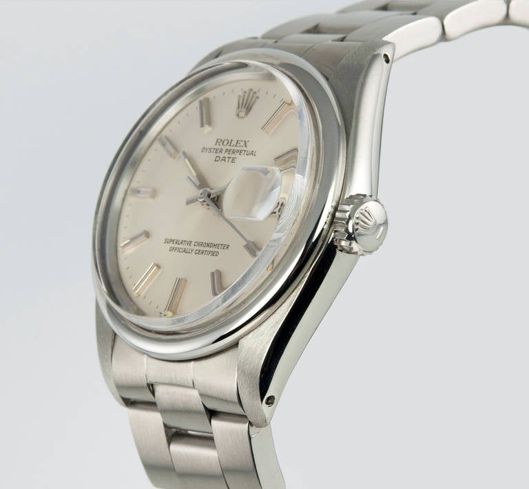 Rolex Date model wristwatch in stainless steel, reference 1501. This watch features a 34mm case with an original silver satin dial, smooth stainless steel bezel, a 31 jewel automatic movement, plastic crystal, locking waterproof crown and steel