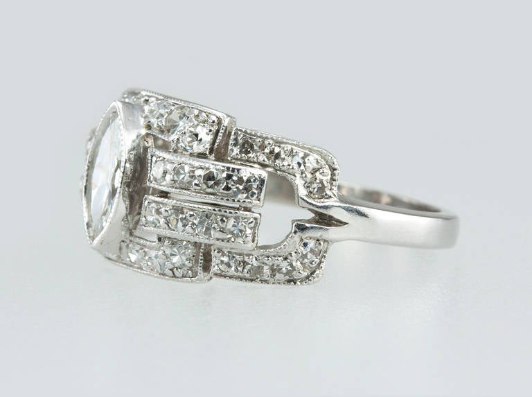 Gorgeous Art Deco diamond ring which features a marquise cut diamond at the center, approximately 0.30 carats H-I VS2 along with 44 single cut side diamonds (which total approximately 1 carat in diamond weight) bead set along the band. A great