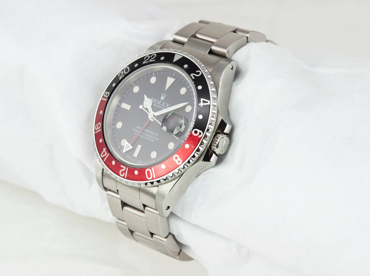 Rolex stainless steel GMT-Master II wristwatch, Ref. 16760, circa 1984. This watch features an automatic movement, quickset date, scratch-resistant sapphire crystal, screw-down crown, stainless steel bi-directional black and red rotating bezel, and