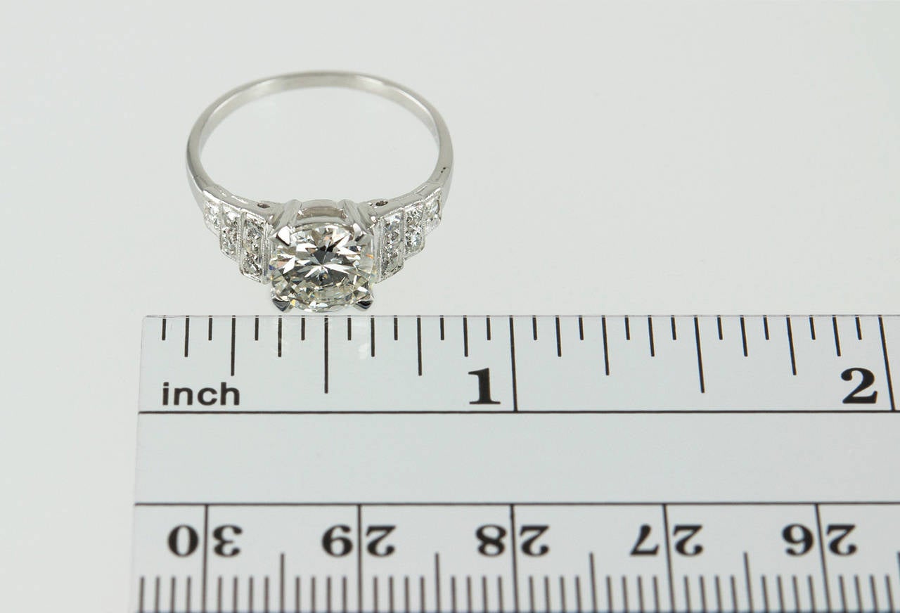 Gorgeous Platinum ring with a  1.31ct Round Brilliant cut  I-VS2 diamond in an Art Deco step mounting with 6 round diamonds on each shoulder.  EGL911269101D.  The size is easily altered to any size.