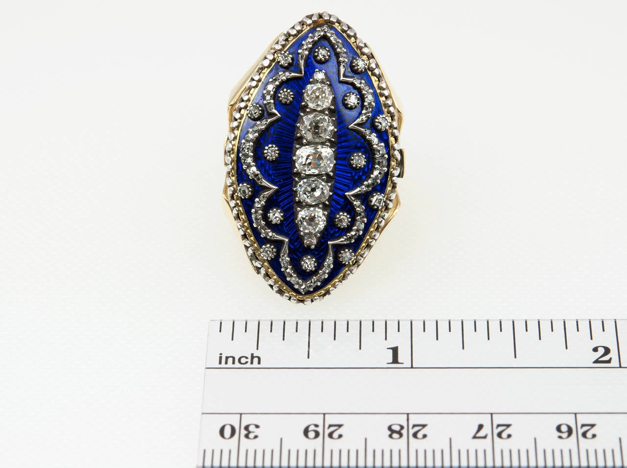 This navette shaped ring is very unique! It has beautiful dark blue enamel with five Old Mine Cut diamonds, which total approximately 1.30 carats of diamonds, with additional small rose cut diamonds in an abstract design in sterling silver over 18