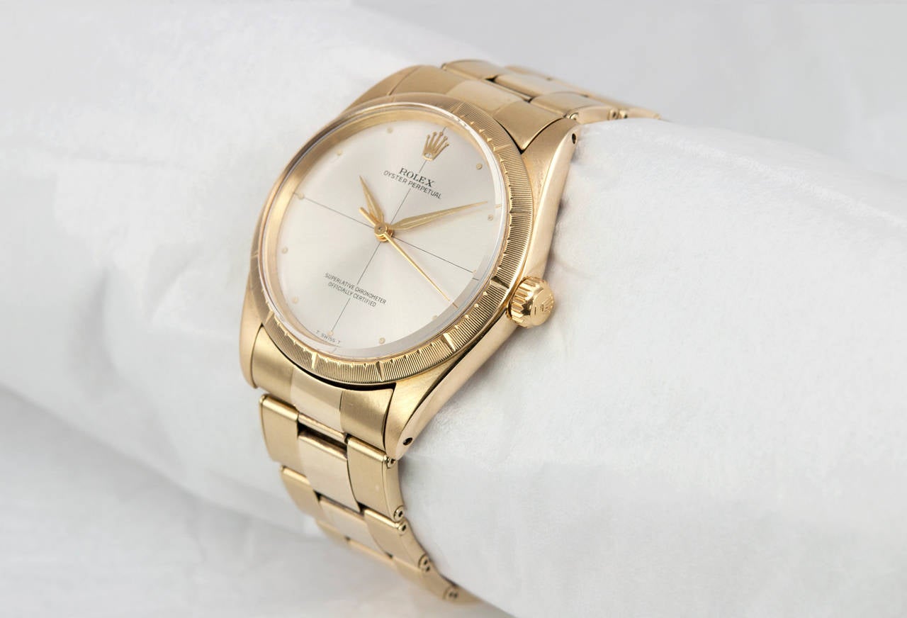 Rolex Yellow Gold Zephyr Wristwatch with Bracelet, Ref. 1008, circa 1960. This beautiful 14k gold Oyster Perpetual automatic watch has a plastic crystal, locking waterproof crown, original Zephyr silvered dial and a riveted gold bracelet. Case
