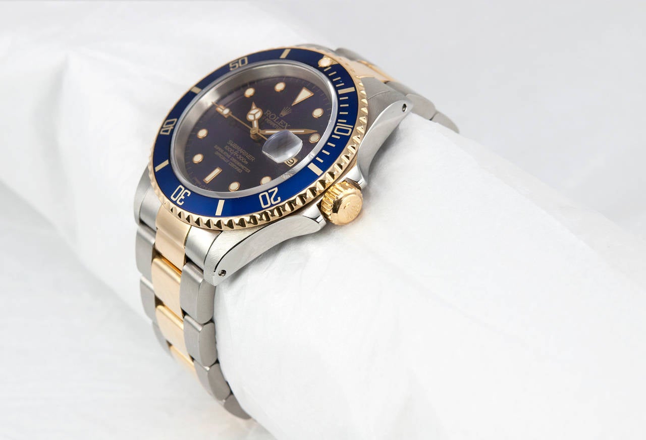 Rolex Submarnier watch in stainless steel and 18k yellow gold, Ref. 16613. This watch has an automatic movement with date, early original blue dial, waterproof screw-down crown, unidirectional rotatable time-lapse diver's bezel, scratch-resistance