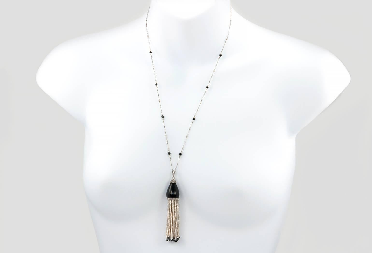 A gorgeous Ghiso platinum sautoir! This necklace features a platinum link 24 inch chain accented with pearls and onyx cabochons.  The tassel is approximately 3 inches in length and is accented with diamonds, onyx, and pearl strands that have great