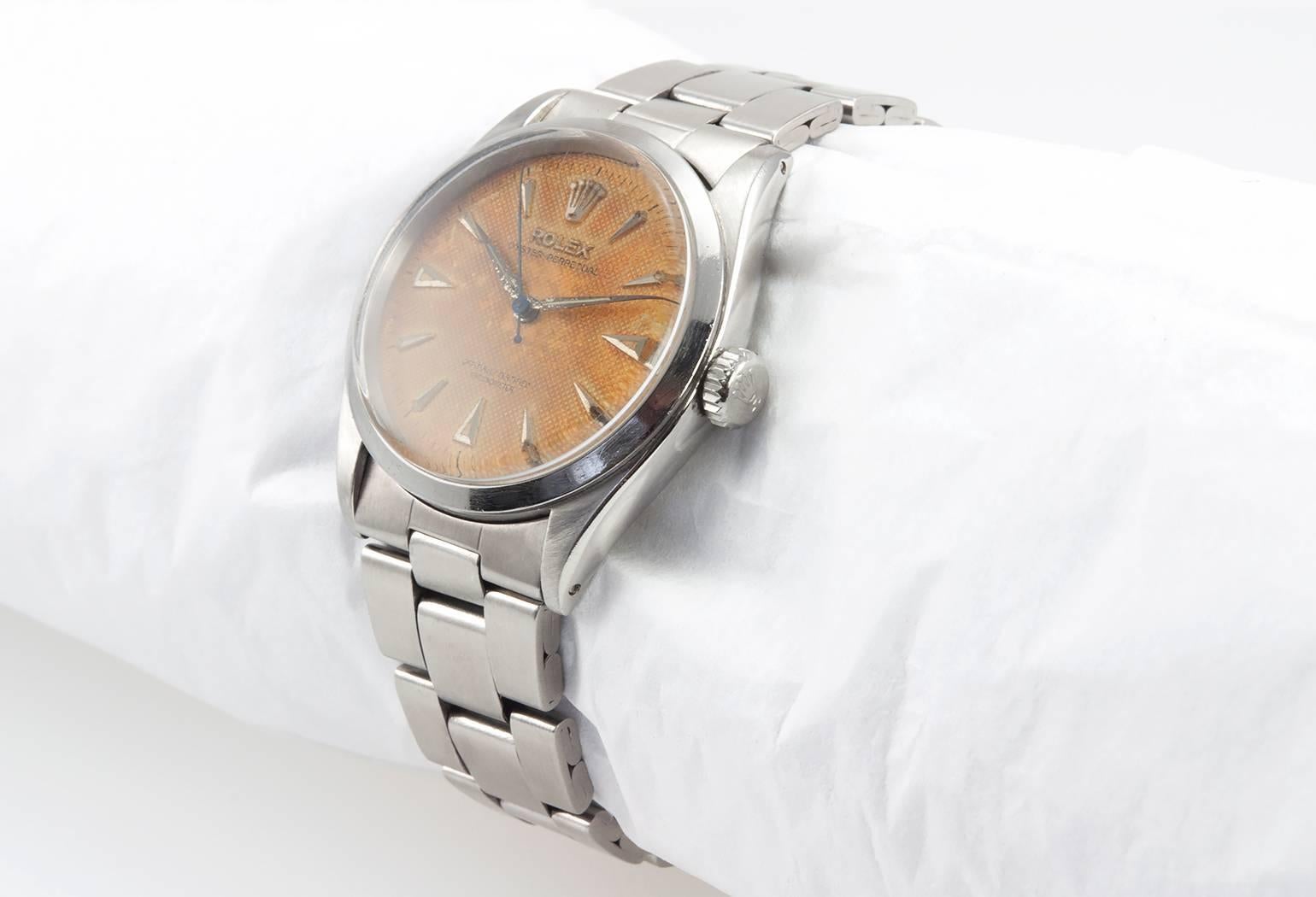 Rolex Oyster Perpetual wristwatch, reference 6284. This Rolex features a plastic crystal, stainless steel locking waterproof crown, folded stainless steel oyster bracelet, original textured waffle dial with pointed markers. Circa 1951.The case