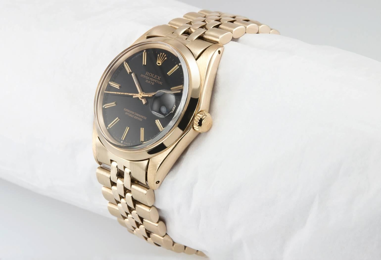 Rolex Date wristwatch in 14 karat yellow gold, reference 1503-8. This classic  Rolex features a 14 karat yellow gold smooth bezel with a yellow gold locking crown, a black original dial, and a 14 karat yellow gold jubilee style bracelet. Circa 1966.