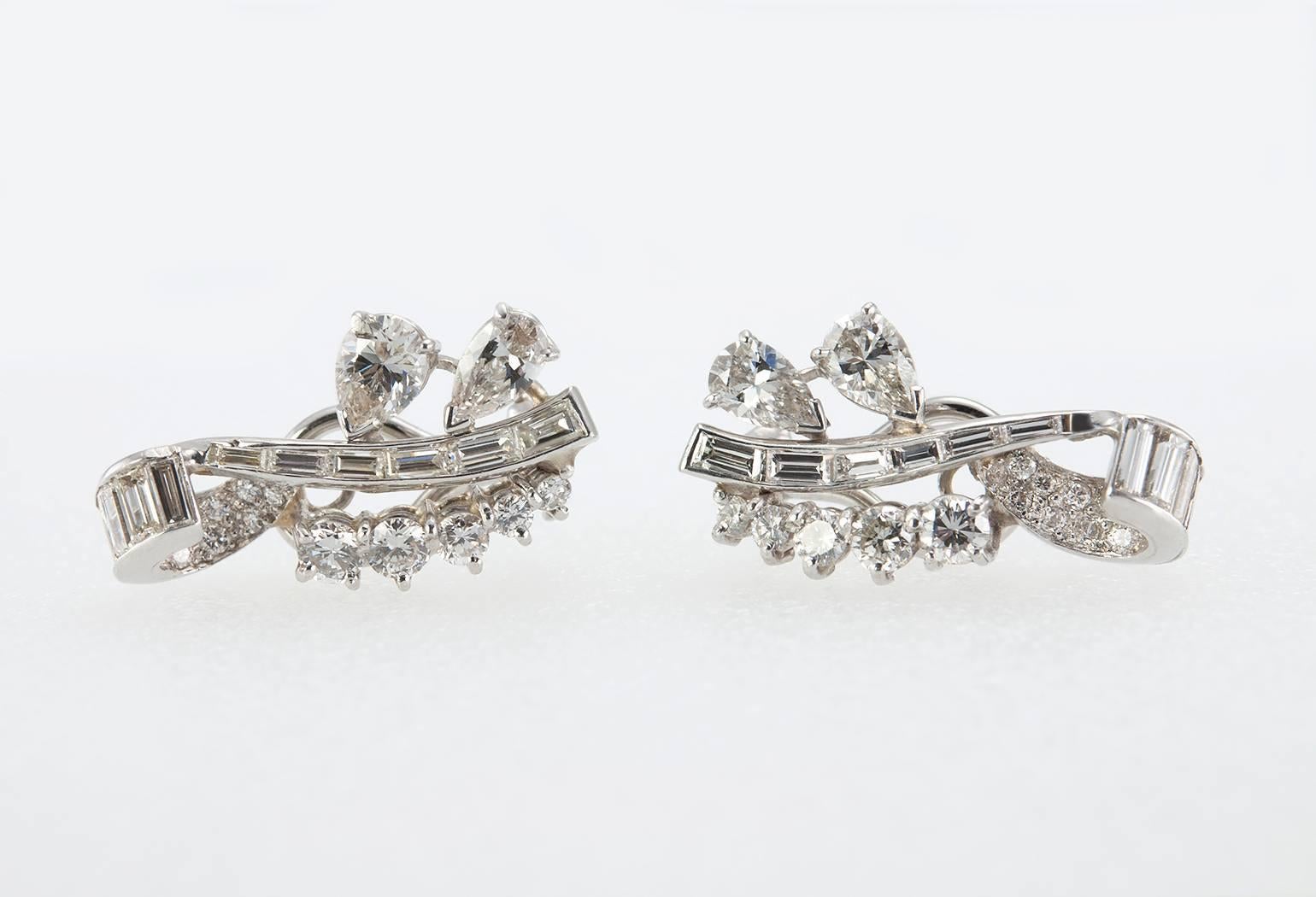 These beautiful diamond and platinum ear crawler earrings clip on and sit comfortably up the ear.  With approximately 3 carats in total diamond weight they really sparkle! The earrings consist of 28 round brilliant cut diamonds, 4 pear shaped