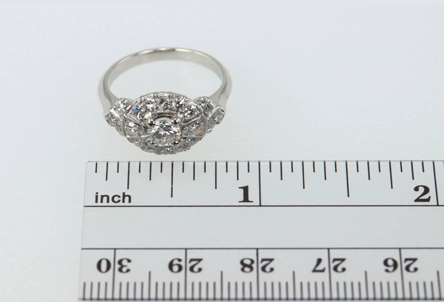 A beautiful diamond and platinum bow-shaped ring.  This ring features a center transitional cut 0.40 carat diamond that is H in color and VS2 in clarity (per EGL certificate) that is surrounded by an additional 18 single cut diamonds which amount to