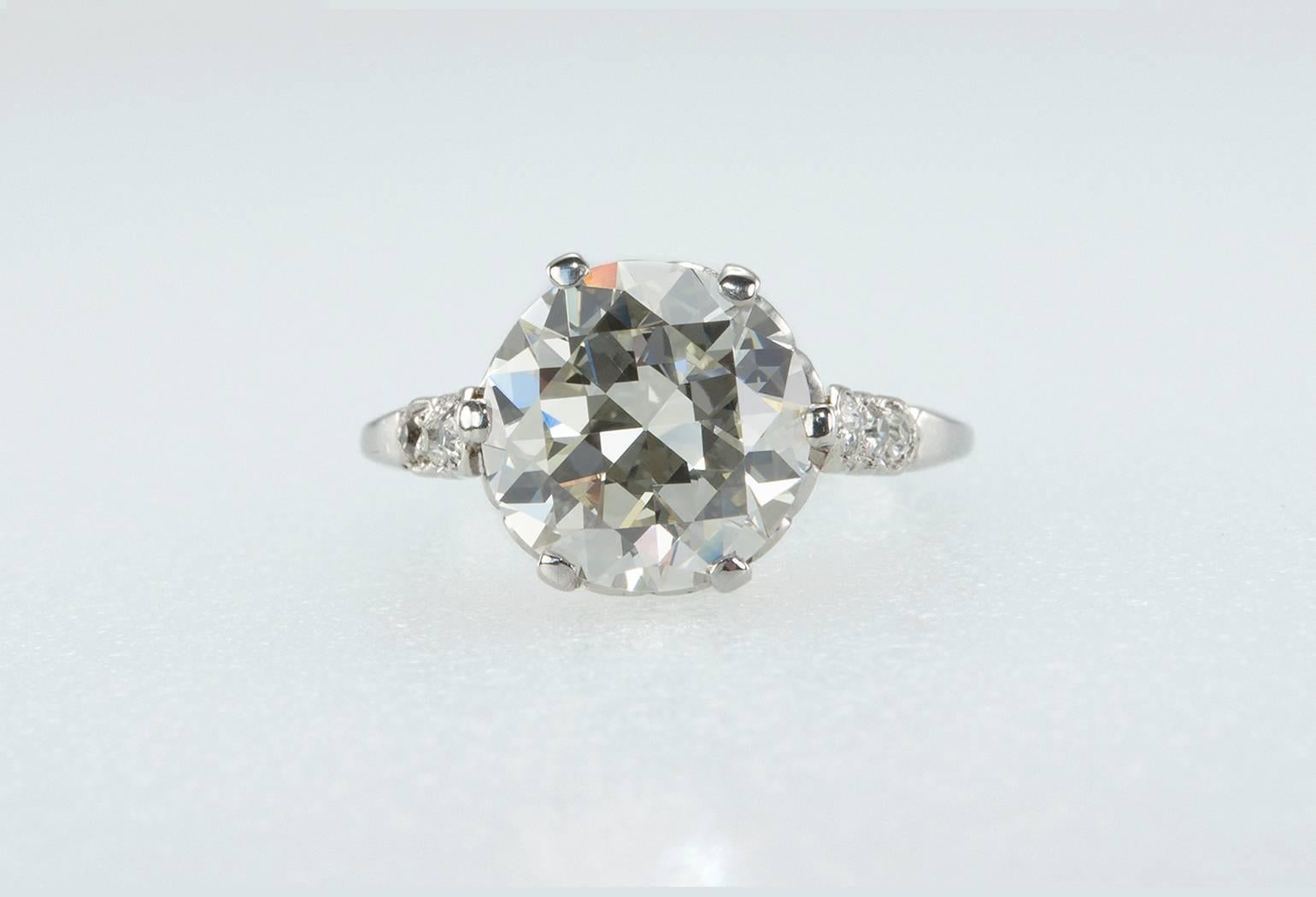 This stunning ring features a 3.36 carat Old European Cut diamond center that is L in color and VS1 in clarity (per EGL certificate).  Both sides of the ring have 3 full old cut diamonds for total diamond weight of approximately 0.16 carats.  Circa