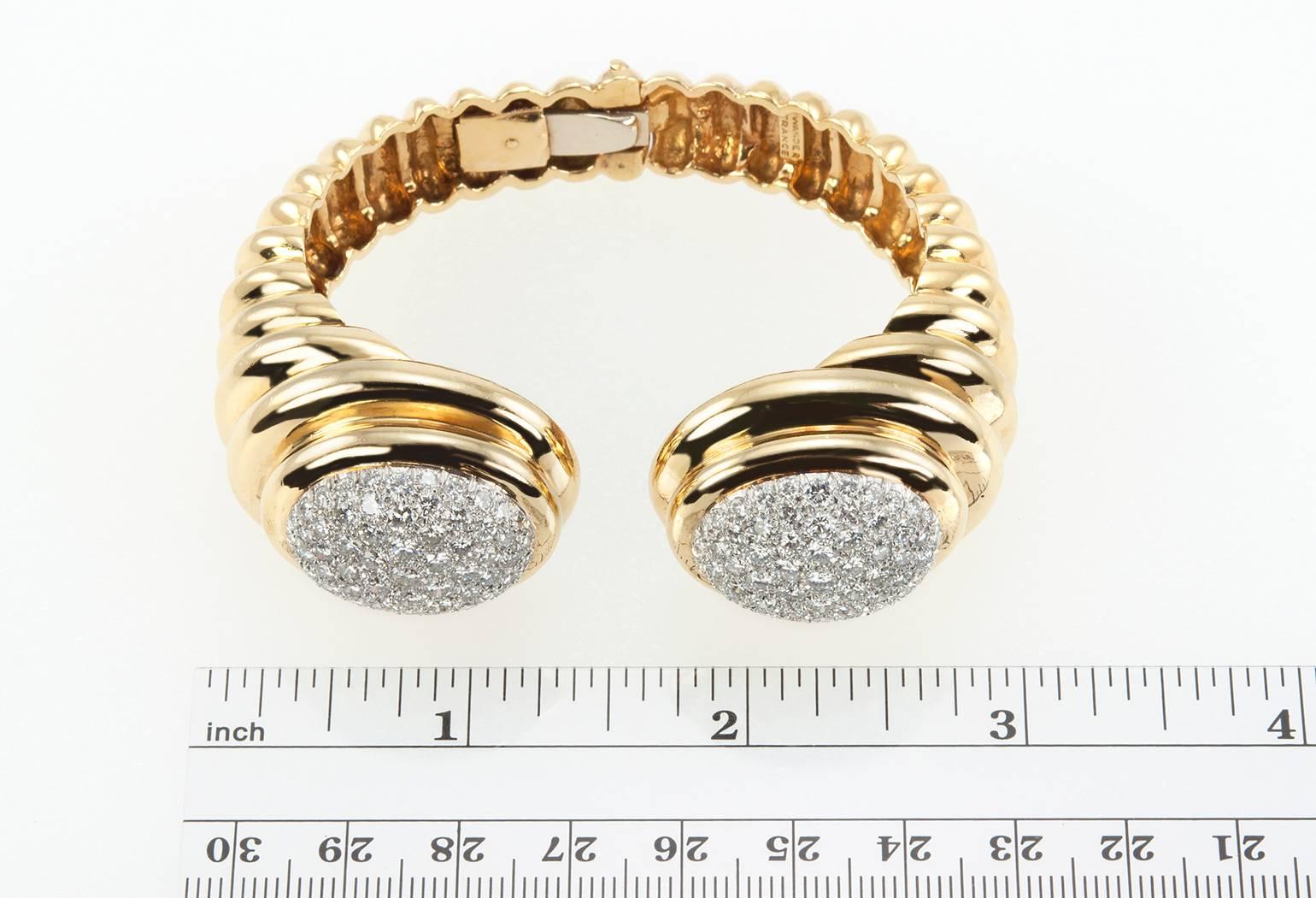 Incredible Wander hinged cuff bracelet in 18 karat yellow gold. The bracelet features 130 round brilliant cut diamonds, which total approximately 10 carats of diamonds. Circa 1970s. 

The bracelet measures approximately 6.75 inches in the inner