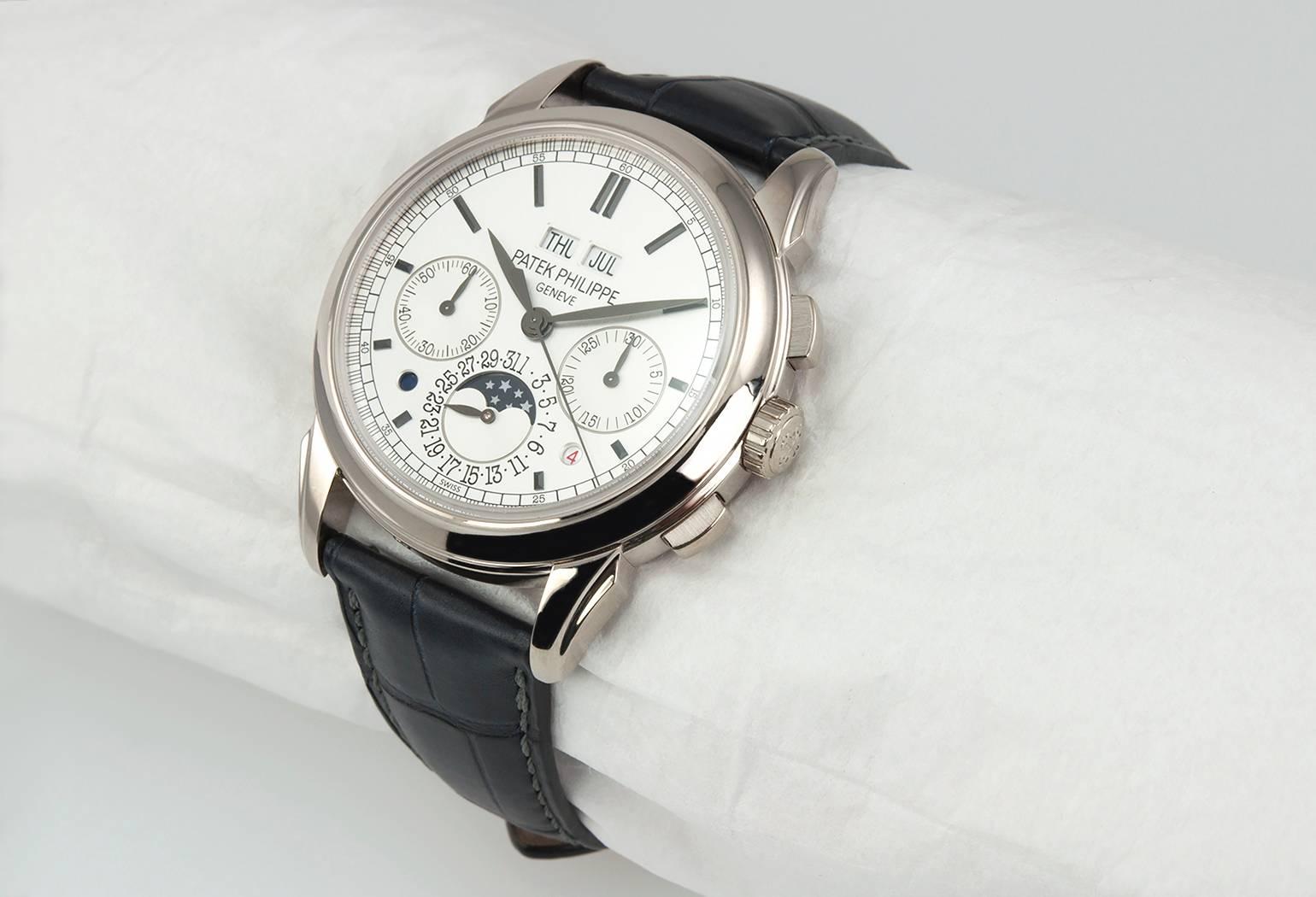 Patek Philippe Grand Complication Perpetual Calendar Chronograph (5270G013) manual-wind watch, features a 41mm 18k white gold case surrounding a silvered dial on a brand new black crocodile strap with an 18k white gold deployment buckle. Functions
