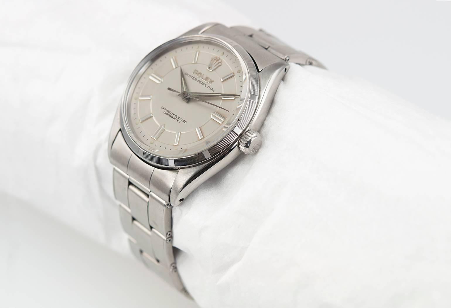 Rolex Oyster Perpetual stainless steel wristwatch, reference 6564. This Rolex watch features a rare refinished white Sector dial, engine turned stainless steel bezel, plastic crystal, locking waterproof crown, riveted oyster bracelet. Circa 1955.