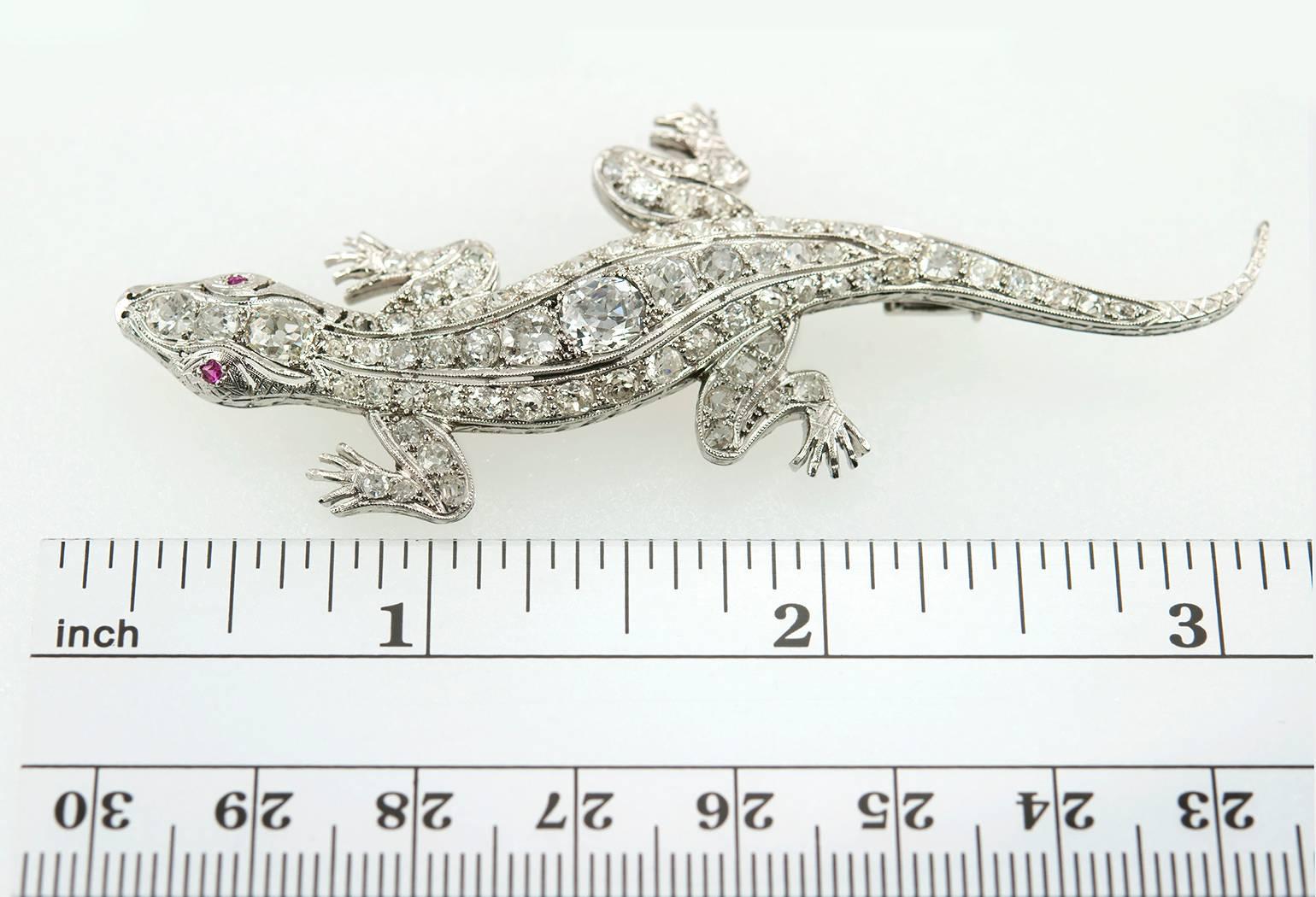 Incredible Edwardian platinum lizard brooch.  This large piece features a center Old Mine Cut diamond approximately 0.70 carats and approximately 4.50 carats in total diamond weight.  Circa 1910.

The brooch is approximately 3.05 inches in length,