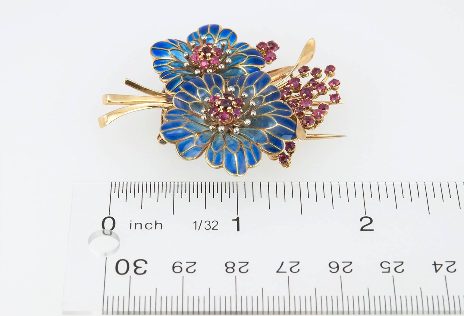A beautiful floral plique-à-jour brooch in 18 karat yellow gold with 36 round rubies. Circa 1960s with French hallmarks.

Brooch measures approximately 2.02 inches in length, 1.88 inches in width, 0.45 inches in depth.