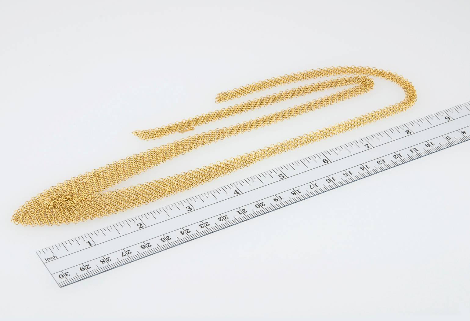 Tiffany and Co. Elsa Peretti mesh bib necklace in 18 karat yellow gold. A chic design by Peretti that is both classic and cool with a malleable form to drape in different ways around the neck.  Circa 1990s.

Necklace is approximately 26 inches in