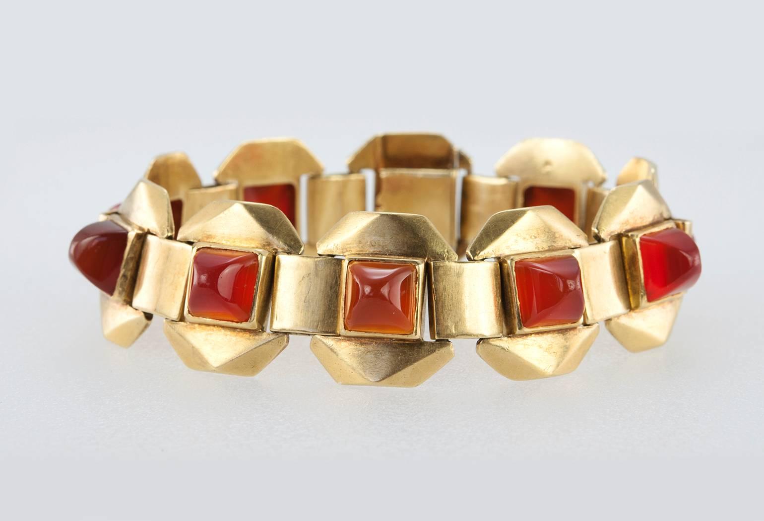 Ghiso carnelian link bracelet in 18 karat yellow gold.  This very cool geometric bracelet features 10 carnelian cabochons cut in the sugar-loaf shape.  Circa 1940s. French hallmarks.

The bracelet measures approximately 7.75 inches in length, 7.5