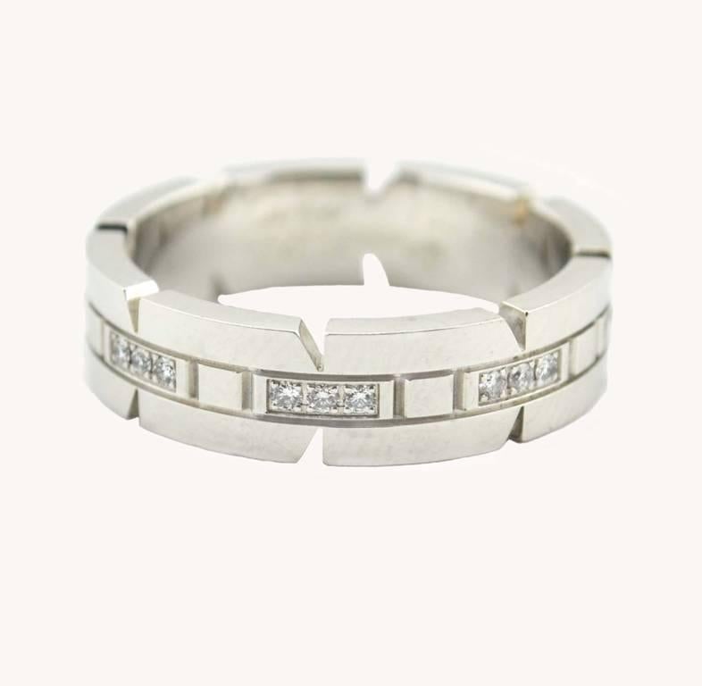 Cartier Tank Francaise band in 18 karat white gold circa 2000s.  This Cartier "small model" ring features 24 brilliant-cut diamonds, which total approximately 0.17 carats in total diamond weight.  Cartier signed and numbered.  

This