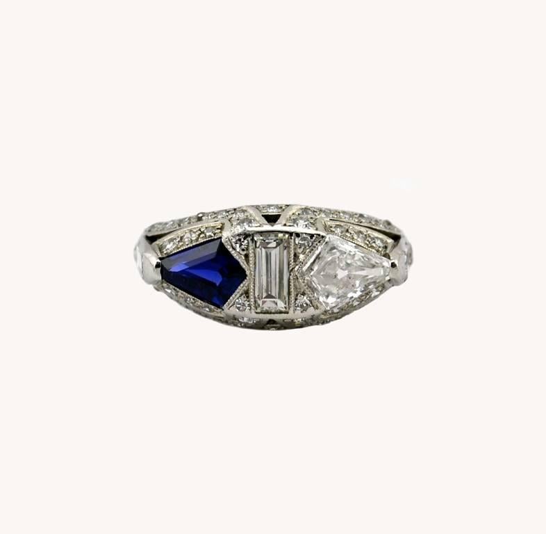 An incredible and unusual platinum Art Deco sapphire and diamond ring from circa 1920.  This beautiful ring features a sapphire approximately 0.80 carats and a diamond that is approximately 0.75 carats, G-H in color and SI2 in clarity.  In between
