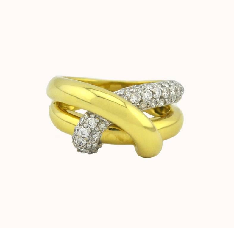 A Fred & Co cool and modern ring.  This twist ring is made in 18 karat yellow gold twist with 43 diamonds set in 18 karat white gold from circa 2000s.  Total diamond weight is approximately 1 carat.  

Currently a US size 6.5 and
