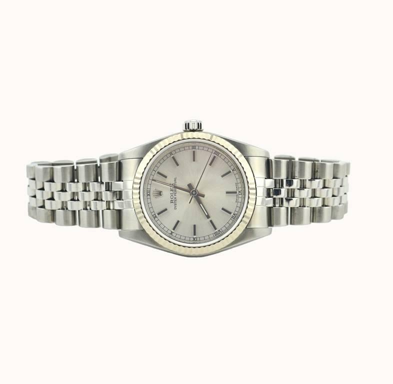A Rolex Oyster Perpetual wristwatch, reference 77014. This classic 31mm unisex model Rolex watch features an 18 karat white gold fluted bezel, stainless steel jubilee bracelet, waterproof stainless steel crown, sapphire crystal, satin color dial,