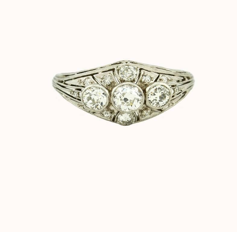 An Art Deco 3-stone diamond ring in platinum from circa 1930.  This ring features 3 bezel set Old European Cut diamonds that are H-I in color and VS in clarity.  The approximate total diamond weight is 1.30 carats.

Currently a US size 6.75 and