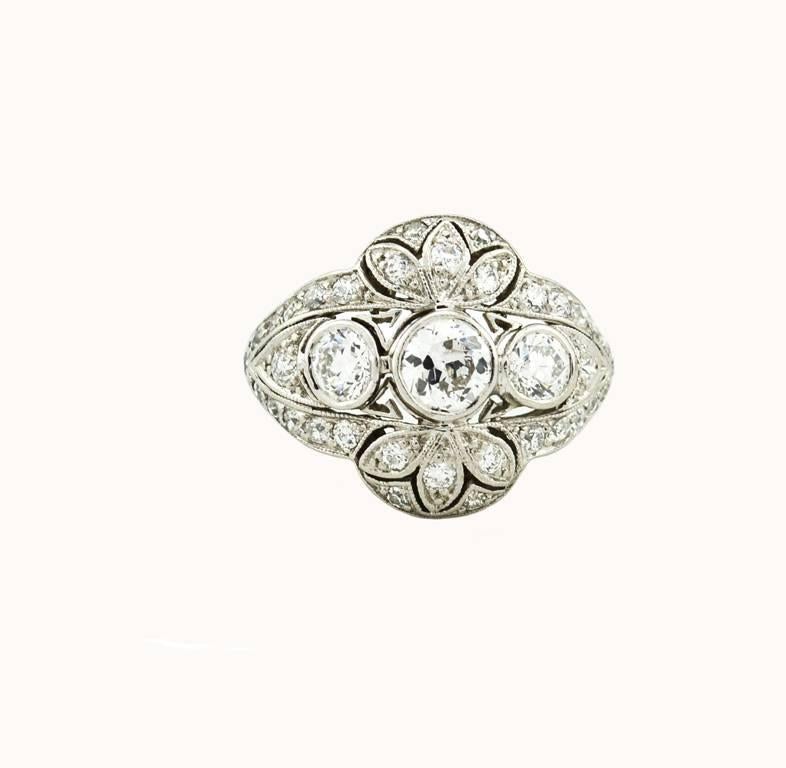 An Edwardian diamond and platinum ring from circa 1910.  This beautiful ring features three Old European Cut diamonds; the center diamond is approximately 0.75 carats, G-H in color, and SI2 in clarity.  The two other diamonds are approximately 0.40