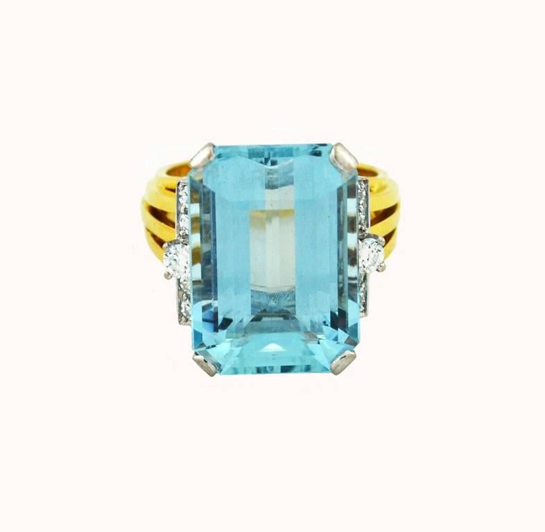 A fantastic, large scale cocktail ring from circa 1960 featuring a beautiful aquamarine.  This ring is crafted in 18 karat yellow gold and platinum with a maker's mark of S+F.  

The aquamarine is approximately 13.80 carats with 10 round brilliant