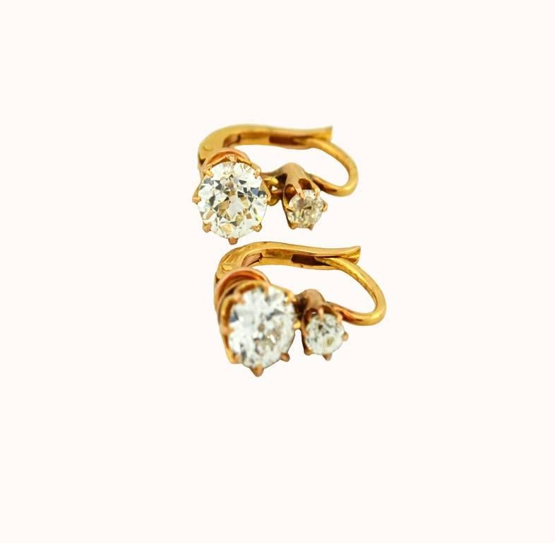 Beautiful and wearable Victorian diamond earrings in 18 karat yellow gold.  The earrings feature two larger Old European Cut diamonds on bottom, one approximately 0.95 carats, J-K in color and SI clarity and the other one approximately 0.90 carats,