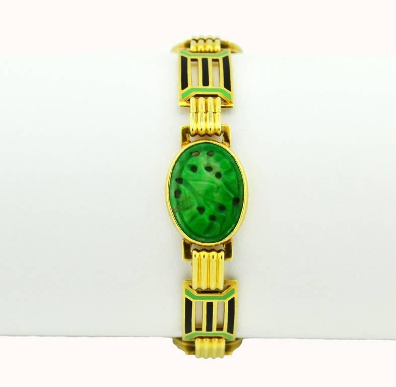An Art Deco link bracelet in 14 karat yellow gold by Wordley, Allsopp, and Bliss circa 1920.  This very cool piece features green and black enamel work and 3 pieces of carved jade.  

The bracelet measures approximately 7.25 inches in length and