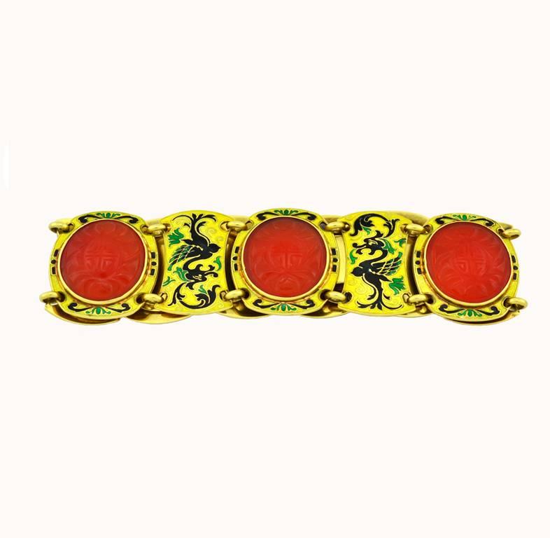 An Art Deco chinoiserie gold link bracelet 18 karat yellow gold from circa 1930.  This very cool bracelet is decorated with Chinese motifs using vibrant yellow, green, and black enamel and 5 pieces of carved carnelian.  

This bracelet measures