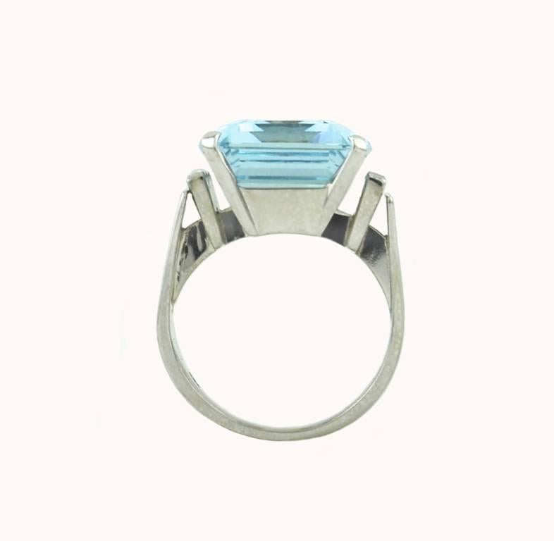 A chic aquamarine and diamond cocktail ring in 18 karat white gold from circa 1960.  This ring features a beautiful 14.05 carat aquamarine with 4 baguette diamonds on the sides. The diamonds are H-I in color and VS in clarity and the approximate