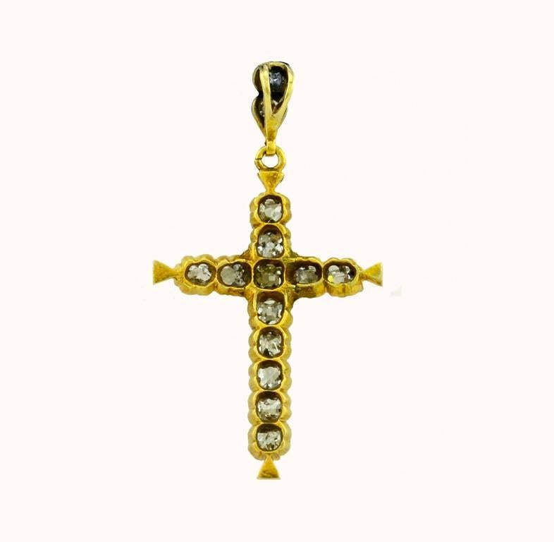A beautiful antique Victorian cross in 14 karat yellow gold.  This pendant features 12 Old Mine Cut diamonds and 2 Old European Cut diamonds for an approximate total diamond weight of 1.50 carats.  The diamonds are H-K in color and SI in clarity. 