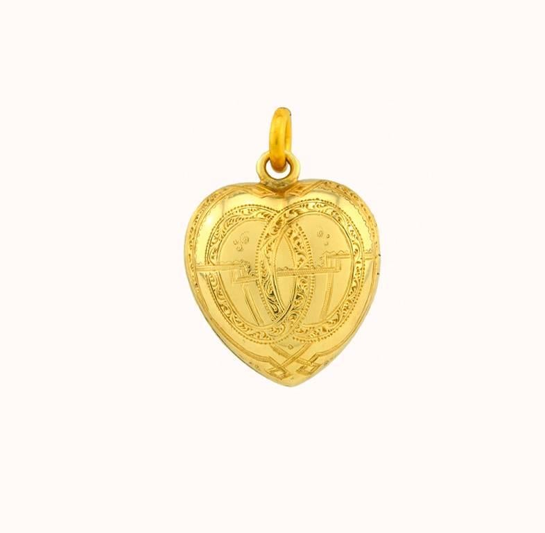 An incredible Victorian heart-shaped locket with black enamel detail in 18 karat yellow gold from circa 1890.  This locket features an approximate 0.45 carat Old Mine Cut diamond in the center with an additional 41 chunky Old Mine Cut diamonds set