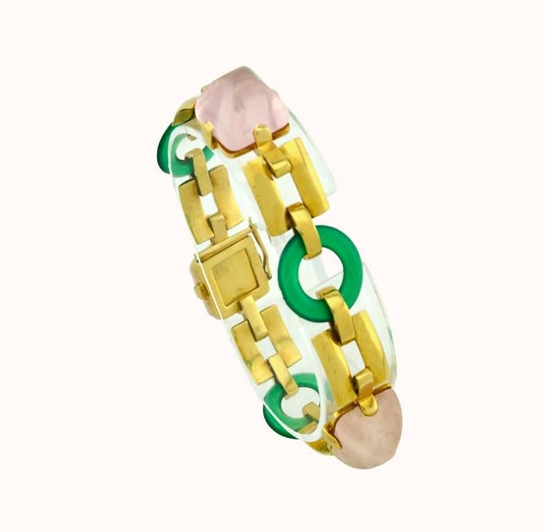 A very cool retro 18 karat yellow gold link bracelet from circa 1950.  This bracelet features 3 rose quartz sugar loaf cabochons and 3 chrysoprase discs with semi-matte gold links in between.  

This bracelet measures approximately 7.5 inches in