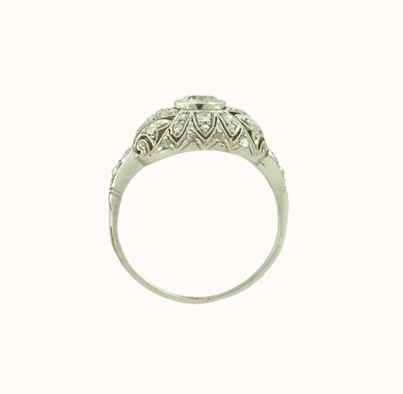 Platinum Edwardian filigree Engagement ring with an approximately 0.35 carat round Old European cut diamond, I-SI1.  The beautiful mounting is covered with rose cut diamonds. Circa 1920  So feminine.  Currently size 7 1/2 and easily altered.   