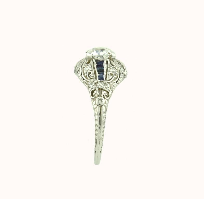 A beautiful Art Deco platinum engagement ring from circa 1930.  This ring features a 0.66 carat Old European Cut diamond that is E in color and VS2 in clarity (per EGL certificate) with sapphire accents. 

EGL certificate included.
Currently a US