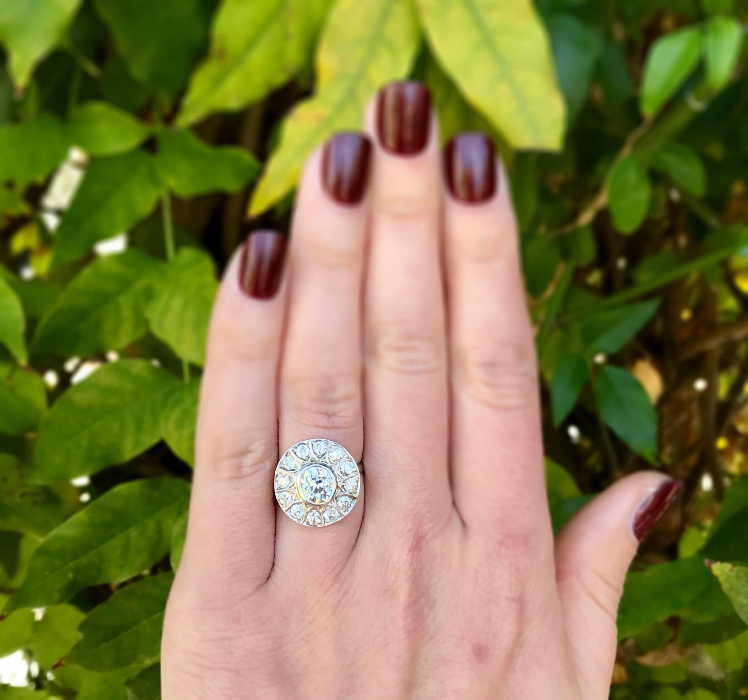 A gorgeous Art Deco cluster ring in platinum from circa 1930 filled with chunky, Old Mine Cut diamonds.  The center Old Mine Cut diamond is approximately 1.25 carats and is J-K in color and VS in clarity.  The surrounding Old Mine Cut diamonds total