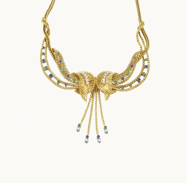 Chic retro 18k yellow necklace made by Carl Bucherer in the 1960s.  Set with 0.50 carat of diamonds along with sapphires and emeralds.  The necklace is 16.75 inches around.  