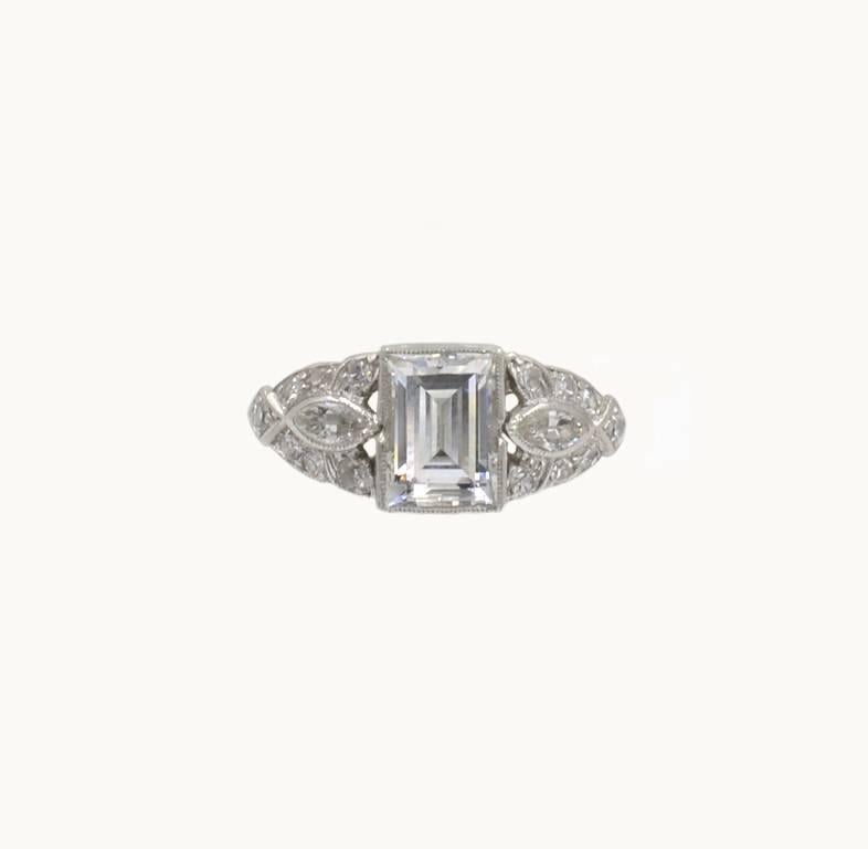 Stunning Art Deco Engagement ring with a 0.94ct Emerald Cut diamond, D-VS1 GIA certificate.  Set with marquise and round side diamonds.  Circa 1930.  Size 5 and can easily be altered.


