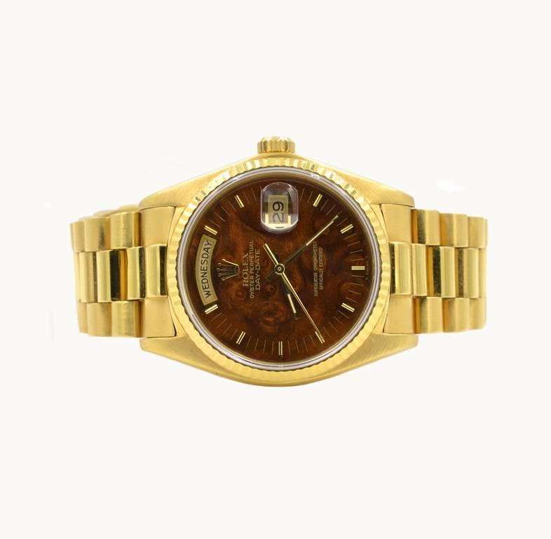 Rolex President Day Date wristwatch, reference 18038. This classic Rolex President features a 18 karat yellow gold case and 18 karat yellow gold president bracelet, original wood dial, sapphire crystal, gold waterproof crown. Circa 1982. The case