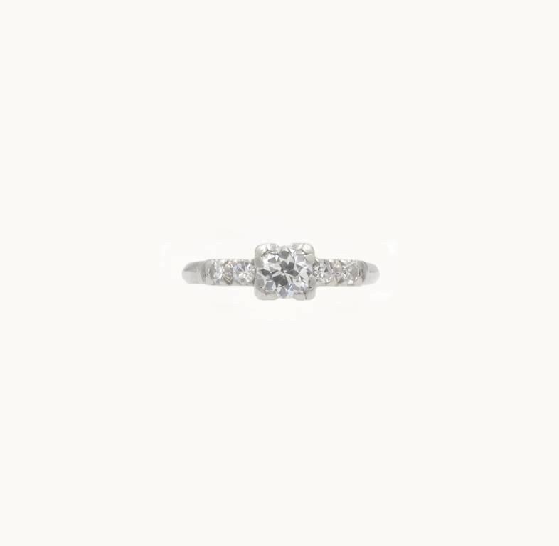 Art Deco diamond and platinum engagement ring from circa 1930s.  This pretty ring features a 0.50 carat Old European Cut diamond that is J in color and SI1 in clarity.  The center diamond is flanked by two single cut round diamonds on each side. 