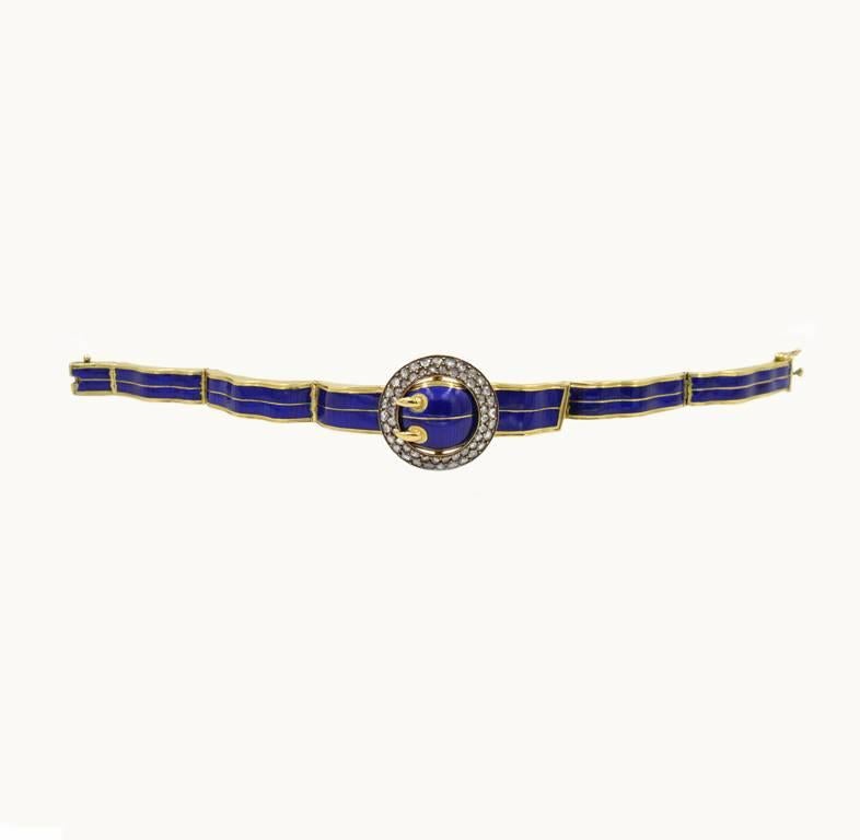 Victorian buckle bangle bracelet in 18 karat yellow gold and blue enamel from circa 1890.  This beautiful bracelet features two rows of rose of 28 rose cut diamonds each.  The rose cut diamonds range in diameter from 1.75 mm-2 mm each.  In fantastic