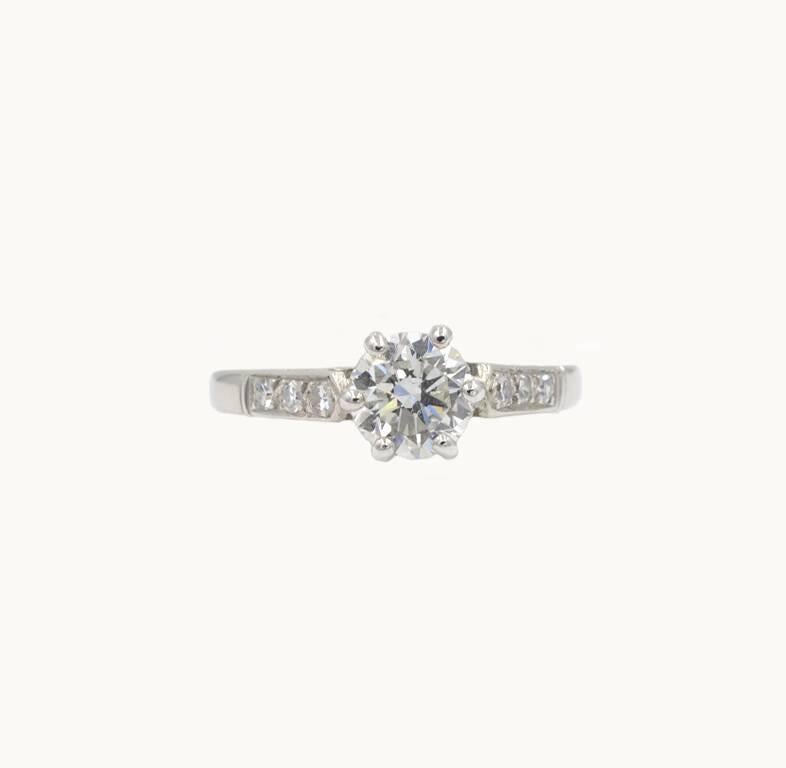 Vintage diamond and platinum engagement ring from circa 1950.  This pretty ring features a 0.73 carat round brilliant cut diamond that is F in color and SI1 in clarity (per GIA certificate).  Additionally, six single cut diamonds decorate the sides