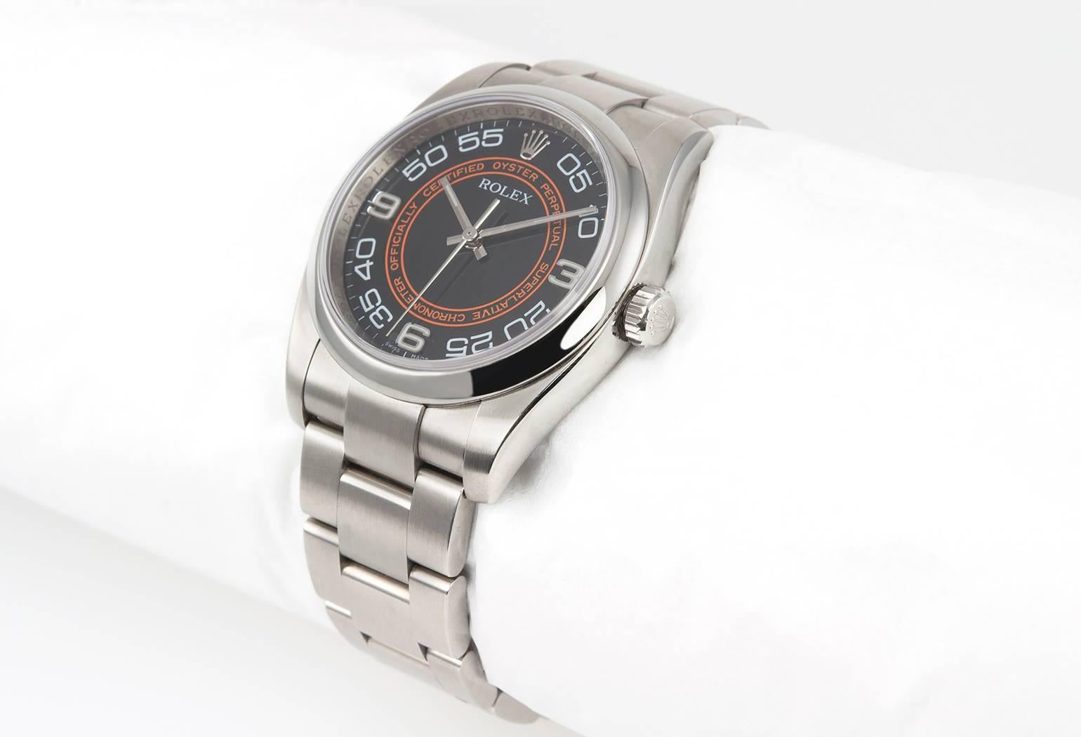Rolex Oyster Perpetual stainless steel wristwatch, reference 116000. This Rolex watch features a black and orange Arabic numeral dial, a stainless steel oyster bracelet, steel waterproof crown, and a sapphire crystal. The case measures 36 mm in