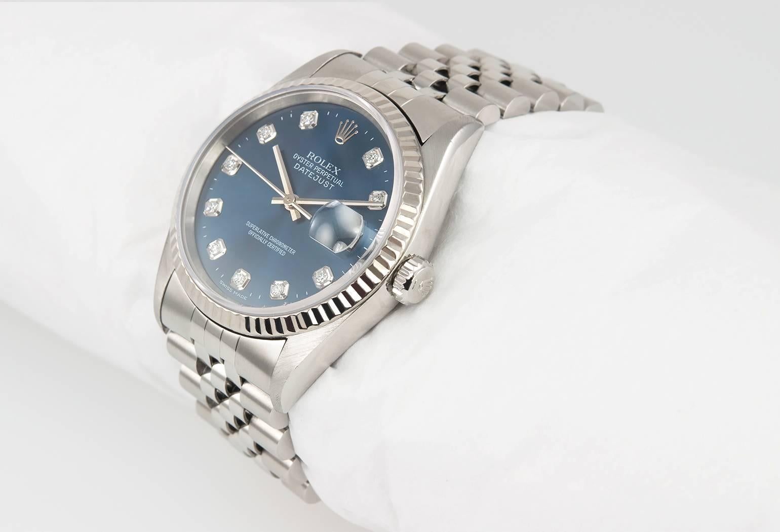 Rolex Datejust wristwatch reference 16234. This classic DateJust Rolex in stainless steel features a blue dial with diamonds, an 18 karat white gold fluted bezel, stainless steel locking waterproof crown, stainless steel jubilee bracelet, and a